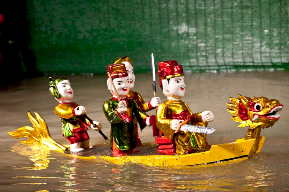 Puppeteers would wade through the water, making wooden puppets appear to dance and interact